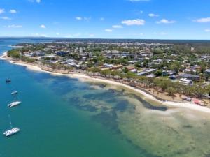 an aerial view of a beach with boats in the water at Sandy Toes in Bellara