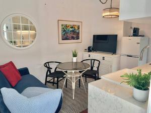 a living room with a couch and a table with chairs at Stylish Private Studio, Close to Beach, WIFI, Parking in Melbourne