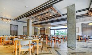 a dining room with wooden tables and chairs at Treebo Tryst Sr House 6 Km From City Palace Of Udaipur in Udaipur