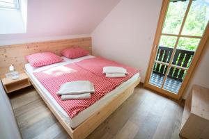 a bedroom with a bed with towels on it at Chalet TISA in Bohinj