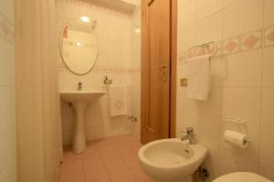 a bathroom with a sink and a toilet and a mirror at Villa Cinzia in Sant'Agnello +6 photos