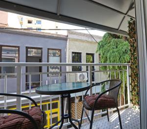 a balcony with a table and chairs on a balcony at CITY CENTER VILLA in Kavála