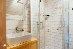 a bathroom with a sink and a shower at Schronisko Stary Młyn in Zakopane +38 photos