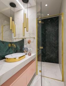 a bathroom with a sink and a shower at Flav Apartment in Kraków