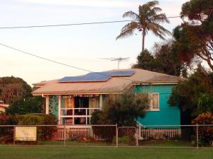 a blue house with a metal roof at 35 Flinders Ave in Dunwich +20 photos