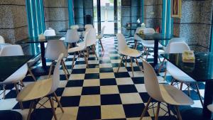 a restaurant with tables and chairs on a checkered floor at Holiday Motel in Tainan