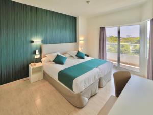 a bedroom with a large bed and a large window at BQ Belvedere Hotel in Palma de Mallorca