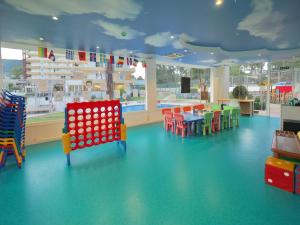 a childrens play area with colorful chairs and a pool at BQ Belvedere Hotel in Palma de Mallorca