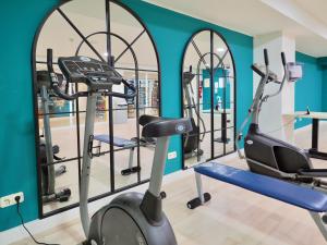 a gym with a treadmill and two mirrors at BQ Belvedere Hotel in Palma de Mallorca