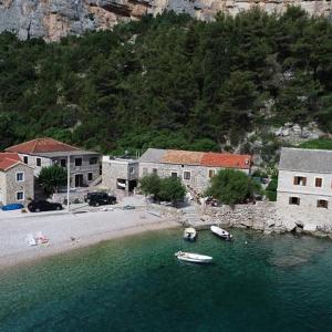 a group of buildings and boats in a body of water at Apartmani Bepin in Selca kod Bogomolja +12 photos
