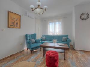 a living room with a couch and a table and chairs at Villa Tranquila in Budva