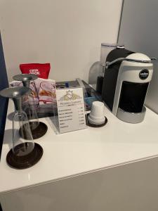 a counter with a coffee maker and a toaster at B&B Rossini Luxury 2 in Cosenza