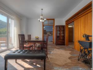 a living room with a table and chairs and a dining room at Villa Tranquila in Budva +19 photos