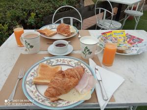 una mesa con dos platos de desayuno y zumo de naranja en Hotel Rural El Pagadín, en Ribadesella