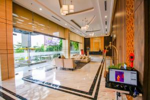 a lobby with a pool in the middle of a building at Asialink Hotel Batam by Prasanthi in Nagoya