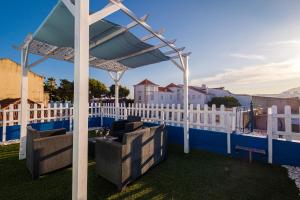 a pergola on a roof with a white fence at Y Quebedo - Boutique Apartments in Setúbal