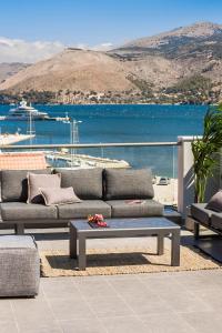 a patio with two couches and a coffee table at The Twelve Suites Collection in Argostoli