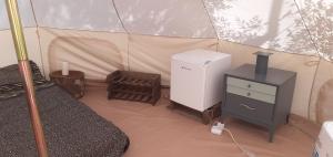 a room with a refrigerator and a stove in a tent at Farm Glamping tent on Acquaviva Bay in Marittima