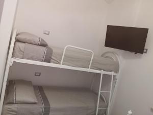 a room with a bunk bed and a flat screen tv at House Pierclaudio e Domitilla in Monte San Biagio +5 photos