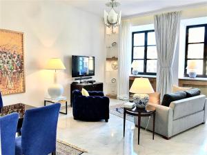 a living room with two couches and a tv at Luxury Apartments MONDRIAN Market Square III in Warsaw