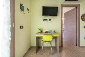 a yellow chair sitting at a table in a room at Larcobaleno di Chia in Domus de Maria