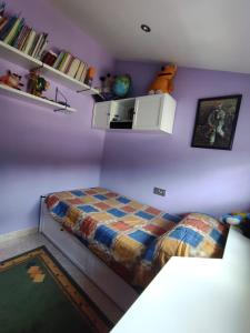 - une chambre avec un lit et un mur violet dans l'établissement CASA DE MELCHOR, à Cruces