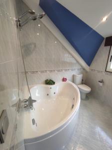 a bathroom with a white tub and a toilet at CASA DE MELCHOR in Cruces +45 photos