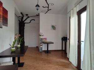 a hallway with a table and a tree on the wall at Casa Janas Affittacamere Bed & Breakfast in Piscinas