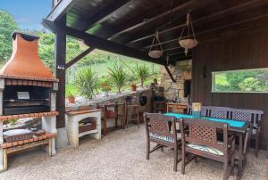 a patio with a stove and a table and chairs at Caserio Urikosolo in Bilbao