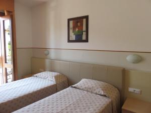 A bed or beds in a room at Hotel Da Si-Si