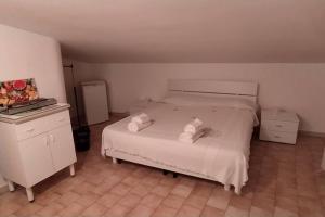 a bedroom with a bed with two towels on it at Via Pisa 20 Mansarda in Bari
