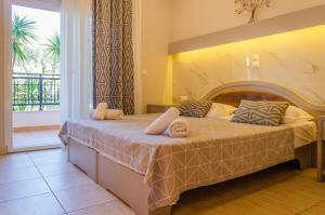 a bedroom with a large bed with a balcony at Villa Eden in Limenas +51 photos