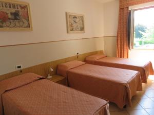 A bed or beds in a room at Hotel Da Si-Si