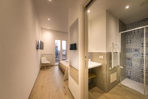 a room with a bathroom with a sink and a mirror at CORESI rooms in Cefalù