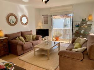 a living room with a couch and a coffee table at Beautiful apartment in the centre of Nerja in Nerja