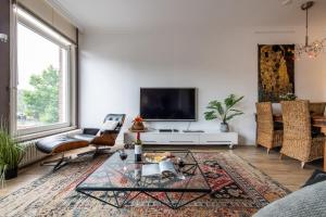 a living room with a tv and a coffee table at Amstel Riverside Apartment in Amsterdam