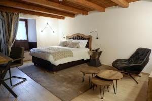 a bedroom with a bed and a table and chairs at Maison Bertin in Etroubles