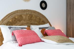 three pillows sitting on top of a bed at Sleepway Apartments - Boho Dream in Poznań