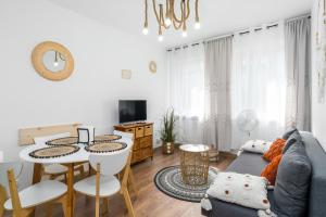 a living room with a couch and a table at Sleepway Apartments - Boho Dream in Poznań