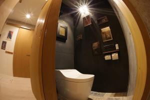 a bathroom with a toilet in a room at Sesoko Blue in Sesoko