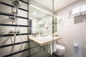 a bathroom with a shower and a sink and a toilet at Hotel Admiral - Liburnia in Opatija