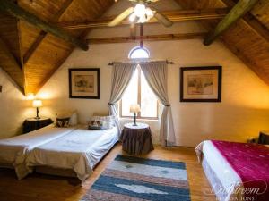 a bedroom with two beds and a window at Glen Aden in Dullstroom