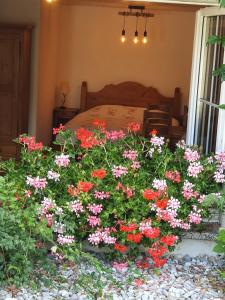 1 dormitorio con 1 cama con flores en el primer plano en B&B Quartenoud, en Treyvaux