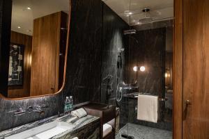 Un baño con lavabo, ducha y espejo. en Mumian Beijing Daxing International Airport, part of Hyatt, en Beijing