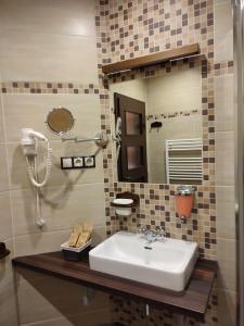 a bathroom with a sink and a mirror at Nábřežní terasy in Žďár nad Sázavou