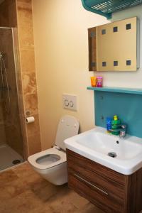 a bathroom with a toilet and a sink and a shower at The Falstaff Ramsgate in Ramsgate +34 photos
