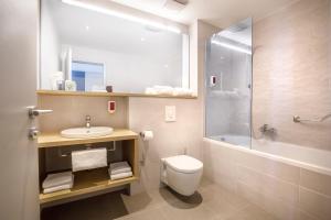 a bathroom with a toilet and a sink and a shower at Hotel Ičići - Liburnia in Opatija