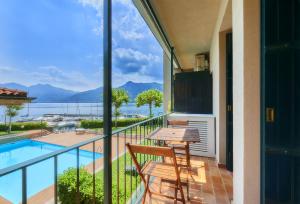 a balcony with a table and chairs and a view of the water at Aria di Breva in Lierna
