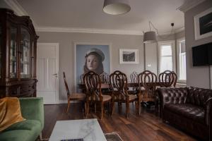 a living room with a painting of a woman on the wall at Akurinn Residence in Akureyri