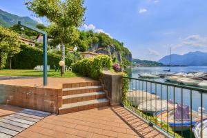 a staircase leading down to a river with boats at Aria di Breva in Lierna